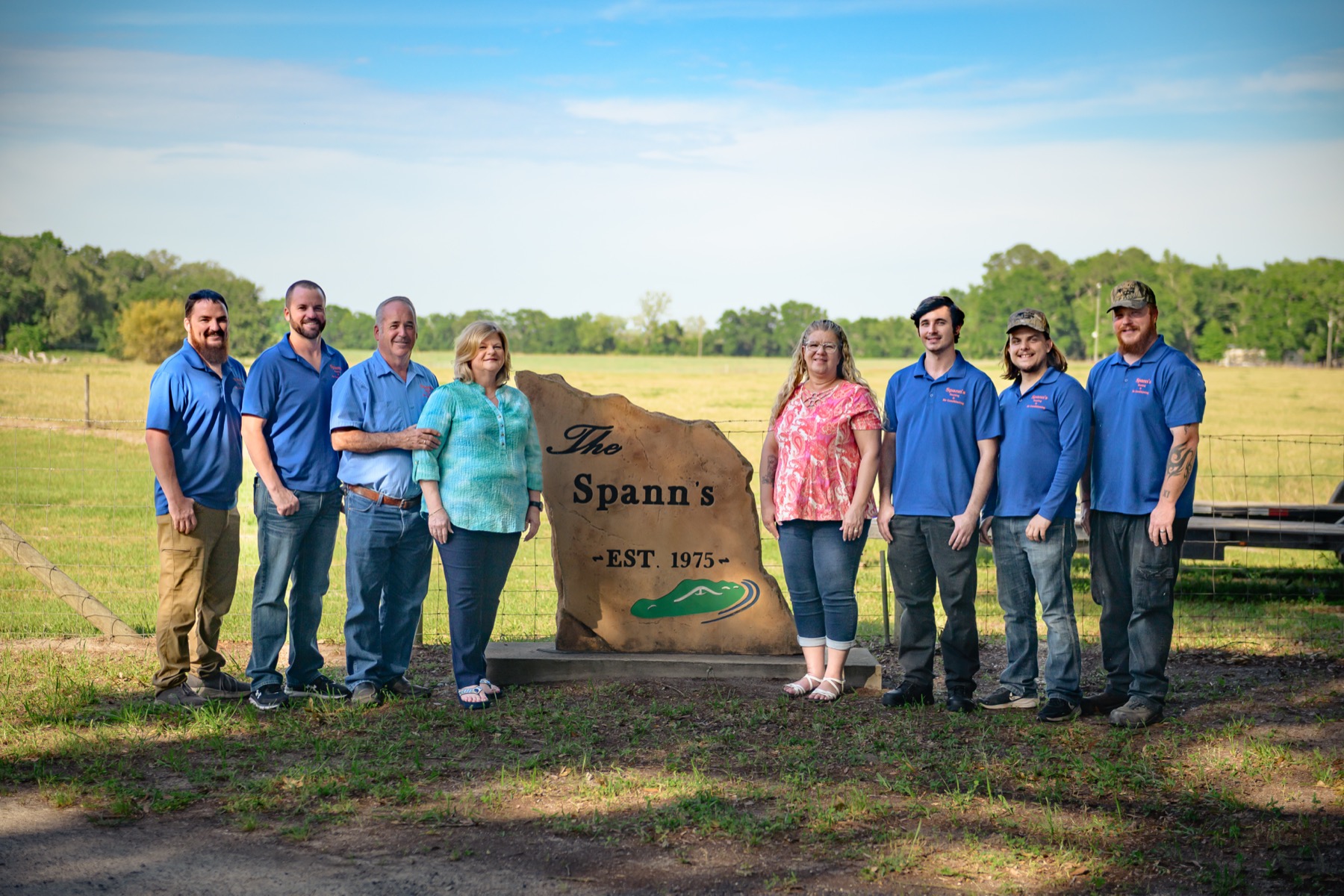 The full Spann family and crew gathered at their Est. 1975 stone