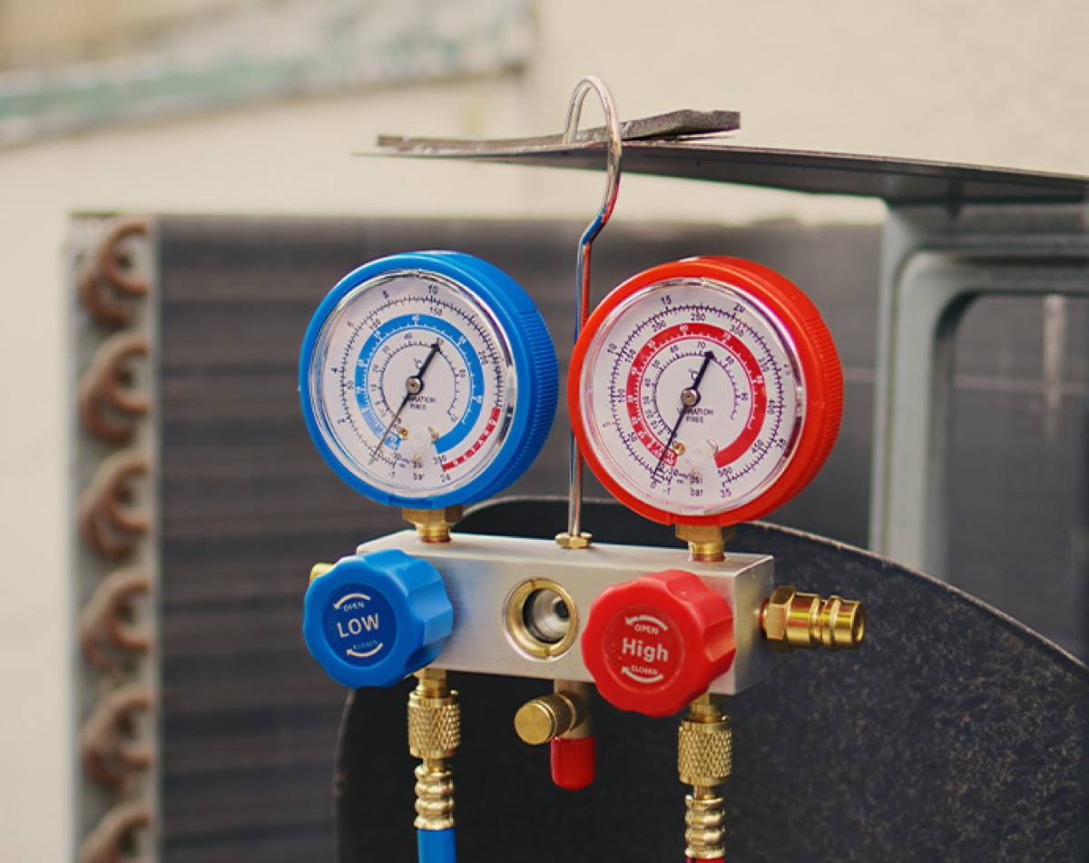 Red and blue refrigerant gauges on a service call